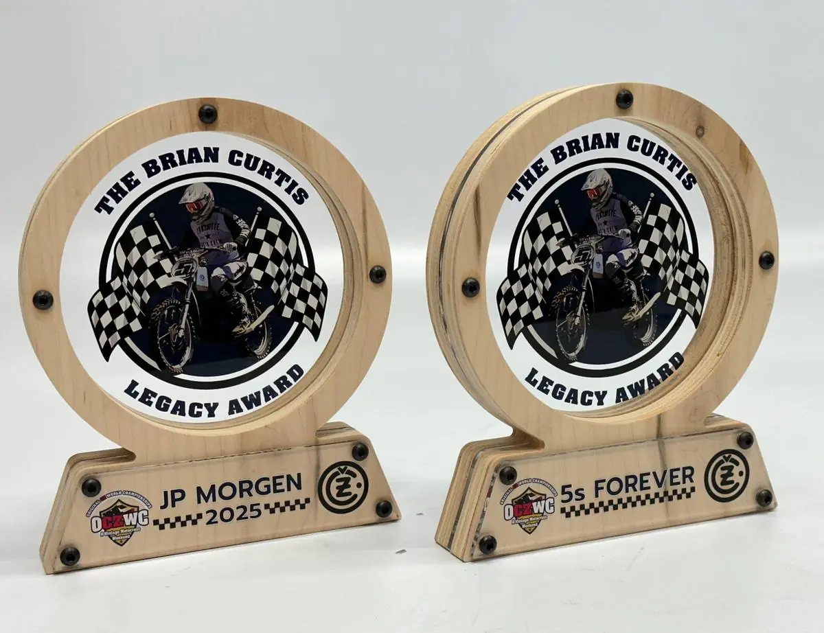 Two wood-and-acrylic ring trophies with a printed rider graphic and a name plate across the base