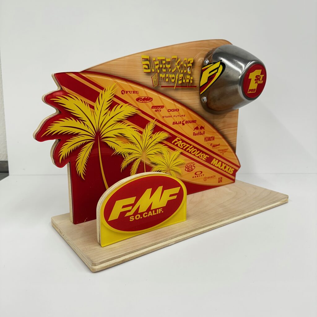 Fully custom award combining a shaped printed acrylic front panel, a wood base and a sponsor logo plate, with a row of sponsor marks printed along the graphic
