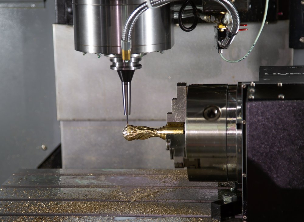 CNC milling machine cutting a brass trophy component