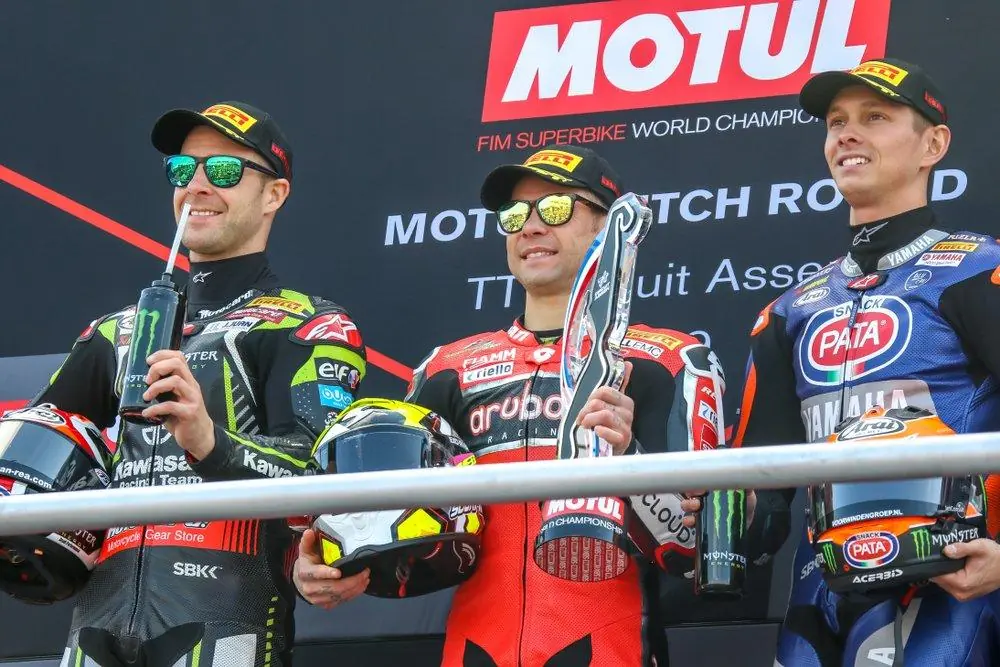 Assen,Netherlands,-,April,12-14,,2019:,World,Superbike,Race,Championship Three superbike riders in leathers on a World Superbike podium, the centre rider holding a trophy