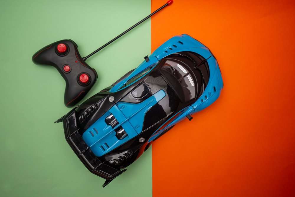 Remote,Controlled,Toy,Racing,Car Overhead view of a blue and black RC race car beside its handheld controller